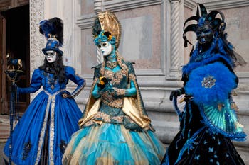 Venetian carnival costumed figures in front of the church of San Zaccaria.