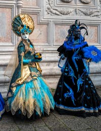 Venetian carnival costumed figures in front of the church of San Zaccaria.