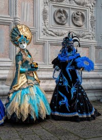 Venetian carnival costumed figures in front of the church of San Zaccaria.