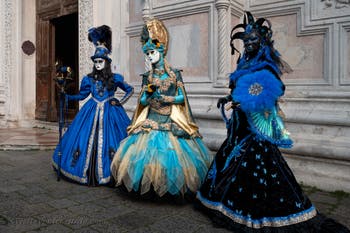 Venetian carnival costumed figures in front of the church of San Zaccaria.