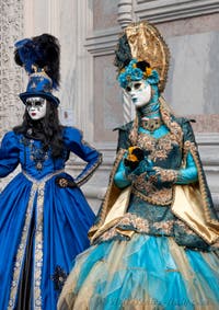 Venetian carnival costumed figures in front of the church of San Zaccaria.