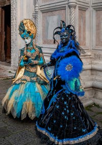 Venetian carnival costumed figures in front of the church of San Zaccaria.