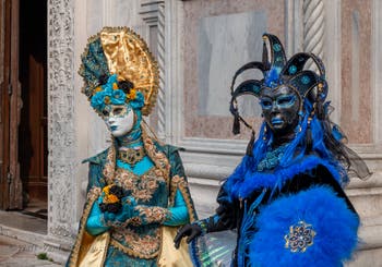 Venetian carnival costumed figures in front of the church of San Zaccaria.