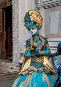 Venetian carnival costumed figures in front of the church of San Zaccaria.