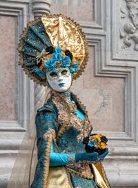 Venetian carnival costumed figures in front of the church of San Zaccaria.