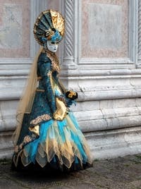 Venetian carnival costumed figures in front of the church of San Zaccaria.