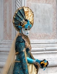 Venetian carnival costumed figures in front of the church of San Zaccaria.