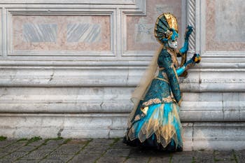 Venetian carnival costumed figures in front of the church of San Zaccaria.