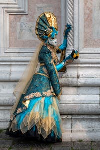 Venetian carnival costumed figures in front of the church of San Zaccaria.