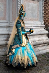 Venetian carnival costumed figures in front of the church of San Zaccaria.