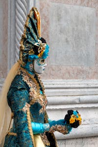 Venetian carnival costumed figures in front of the church of San Zaccaria.