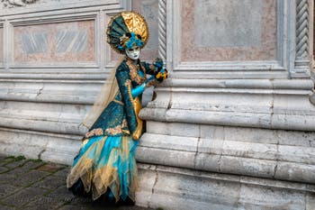 Venetian carnival costumed figures in front of the church of San Zaccaria.