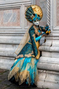 Venetian carnival costumed figures in front of the church of San Zaccaria.