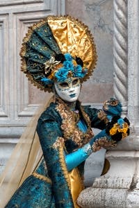 Venetian carnival costumed figures in front of the church of San Zaccaria.