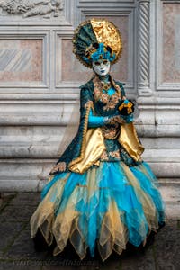 Venetian carnival costumed figures in front of the church of San Zaccaria.