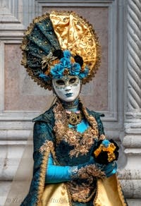 Venetian carnival costumed figures in front of the church of San Zaccaria.