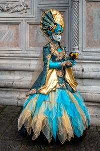 Venetian carnival costumed figures in front of the church of San Zaccaria.