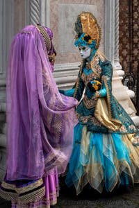 Venetian carnival costumed figures in front of the church of San Zaccaria.