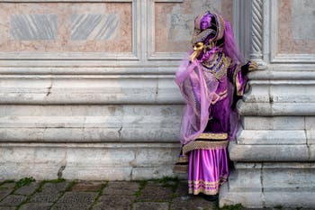 Venetian carnival costumed figures in front of the church of San Zaccaria.