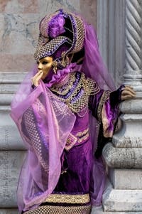 Venetian carnival costumed figures in front of the church of San Zaccaria.