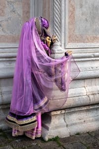 Venetian carnival costumed figures in front of the church of San Zaccaria.