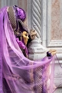 Venetian carnival costumed figures in front of the church of San Zaccaria.