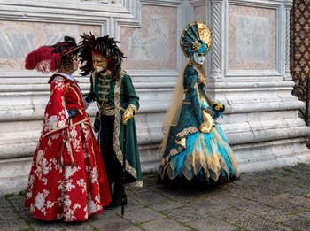 Venetian carnival costumed figures in front of the church of San Zaccaria.