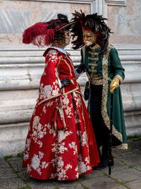 Venetian carnival costumed figures in front of the church of San Zaccaria.