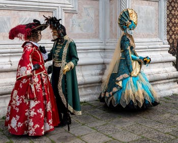 Venetian carnival costumed figures in front of the church of San Zaccaria.