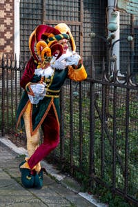 Venetian carnival costumed figures in front of the church of San Zaccaria.