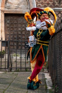 Venetian carnival costumed figures in front of the church of San Zaccaria.