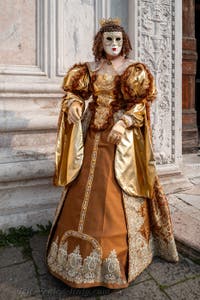 Venetian carnival costumed figures in front of the church of San Zaccaria.