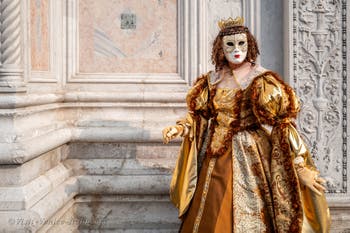 Venetian carnival costumed figures in front of the church of San Zaccaria.