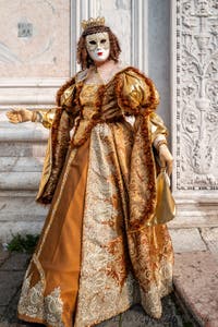 Venetian carnival costumed figures in front of the church of San Zaccaria.