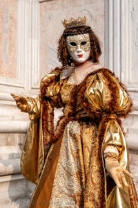 Venetian carnival costumed figures in front of the church of San Zaccaria.