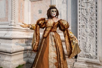 Venetian carnival costumed figures in front of the church of San Zaccaria.