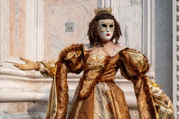 Venetian carnival costumed figures in front of the church of San Zaccaria.