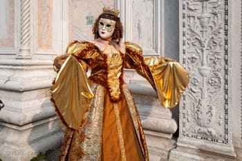 Venetian carnival costumed figures in front of the church of San Zaccaria.