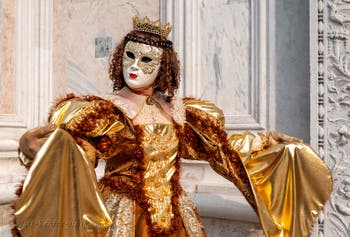 Venetian carnival costumed figures in front of the church of San Zaccaria.