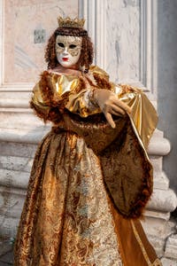 Venetian carnival costumed figures in front of the church of San Zaccaria.