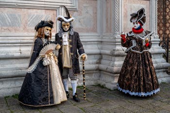 Venetian carnival costumed figures in front of the church of San Zaccaria.