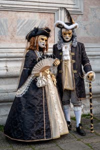 Venetian carnival costumed figures in front of the church of San Zaccaria.