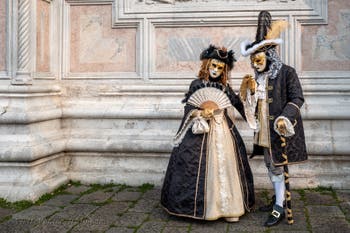 Venetian carnival costumed figures in front of the church of San Zaccaria.