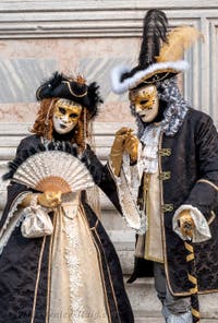 Venetian carnival costumed figures in front of the church of San Zaccaria.