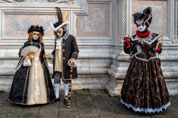 Venetian carnival costumed figures in front of the church of San Zaccaria.