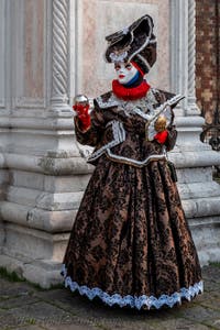 Venetian carnival costumed figures in front of the church of San Zaccaria.