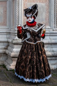 Venetian carnival costumed figures in front of the church of San Zaccaria.