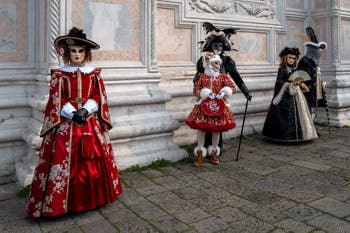 Venetian carnival costumed figures in front of the church of San Zaccaria.