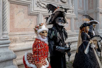 Venetian carnival costumed figures in front of the church of San Zaccaria.