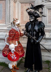 Venetian carnival costumed figures in front of the church of San Zaccaria.